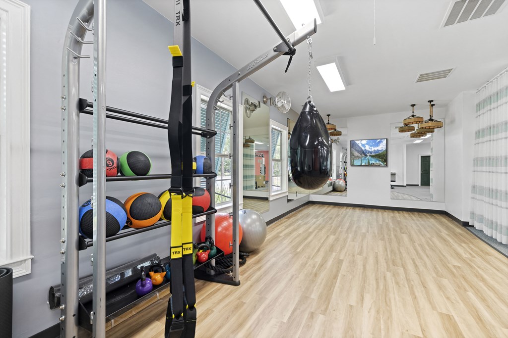 a home gym with weights and a punching bag