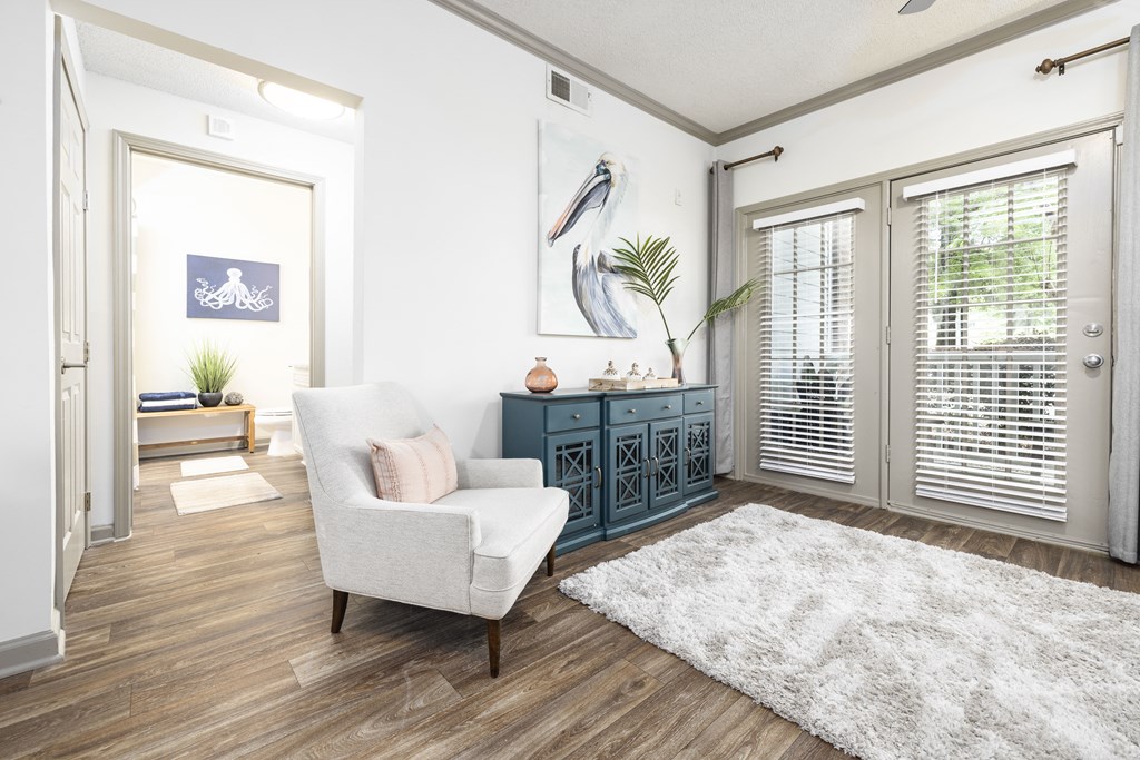 a living room with white walls and wood flooring
