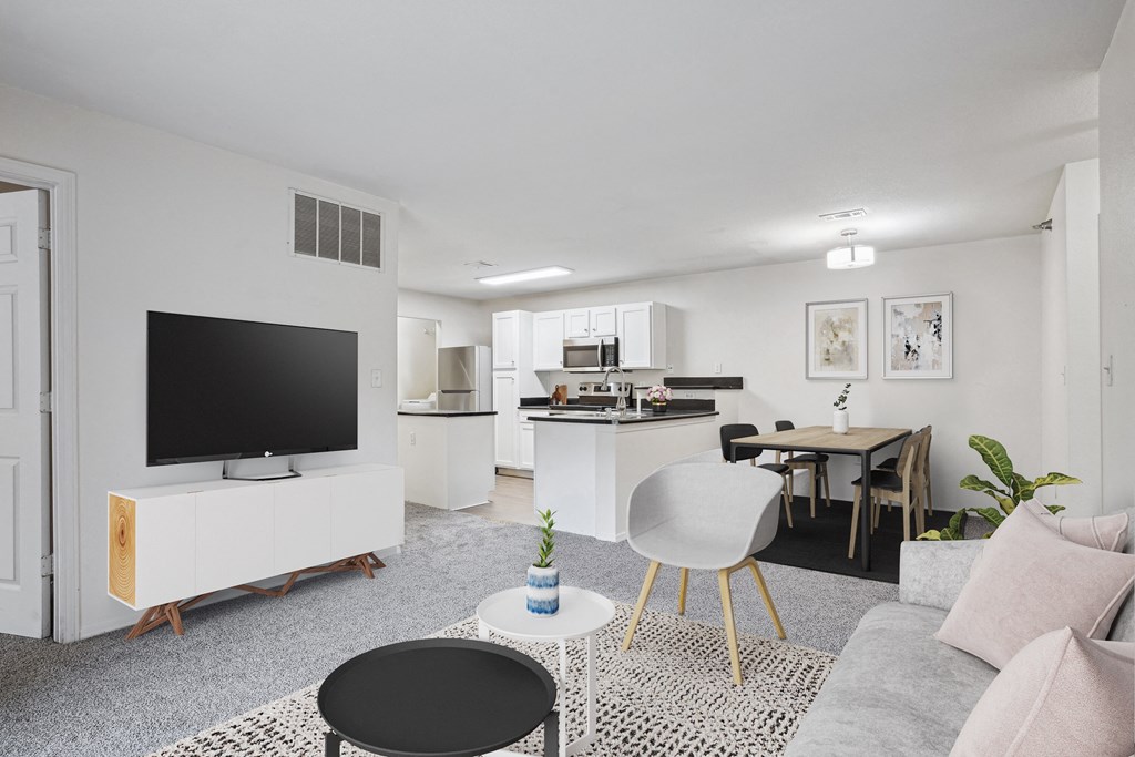 2 & 3-Bedroom Apartments for Rent in Little Rock, AR – Capitol Hill – A modern living room with a television, a dining table, and a kitchen area.