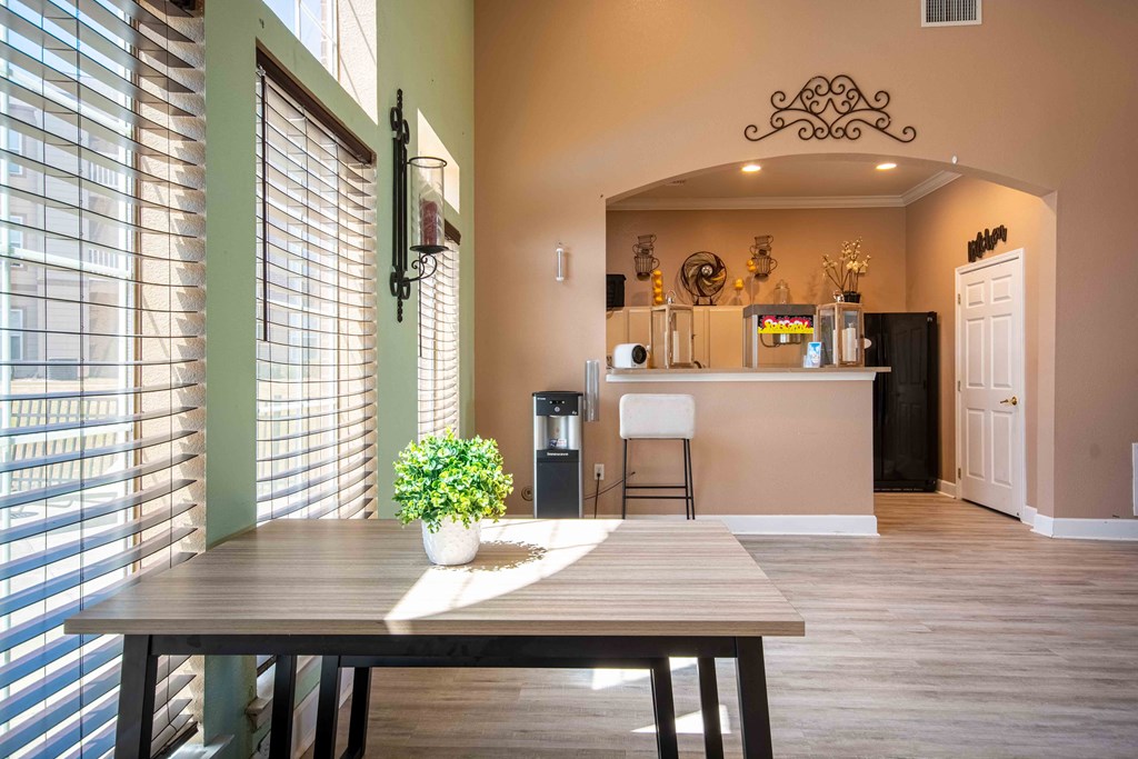 Clubhouse with area to sit at table and chairs with a counter