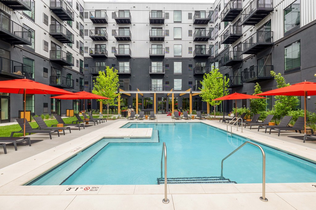 a swimming pool in front of an apartment building