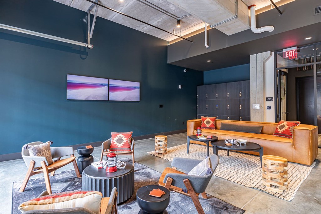 a living room with couches and chairs and a tv