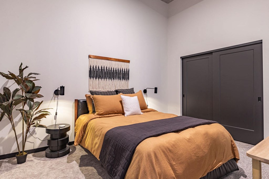 a bedroom with a bed and a black door