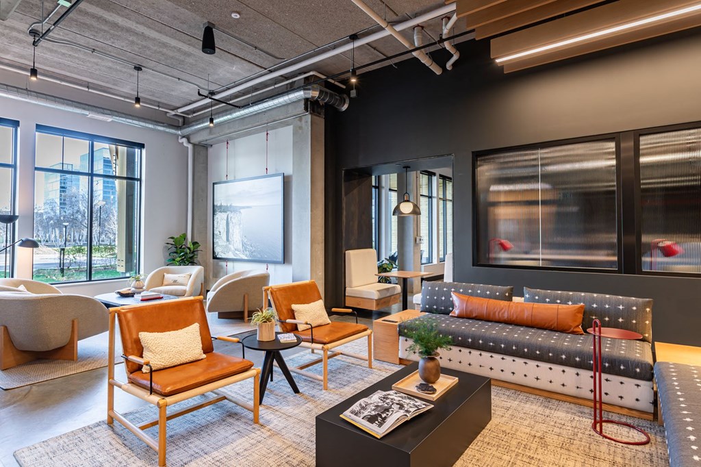 a living room with couches chairs and a table