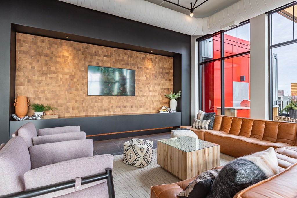 a living room with couches and chairs and a large window