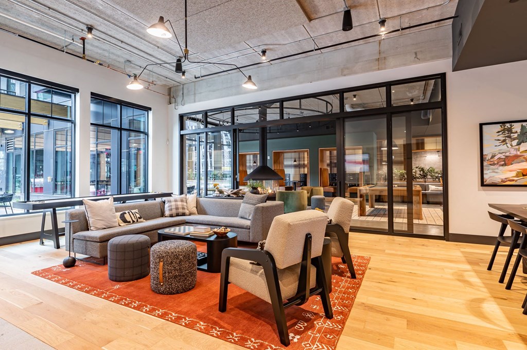 a living room with a couch and chairs in a lobby