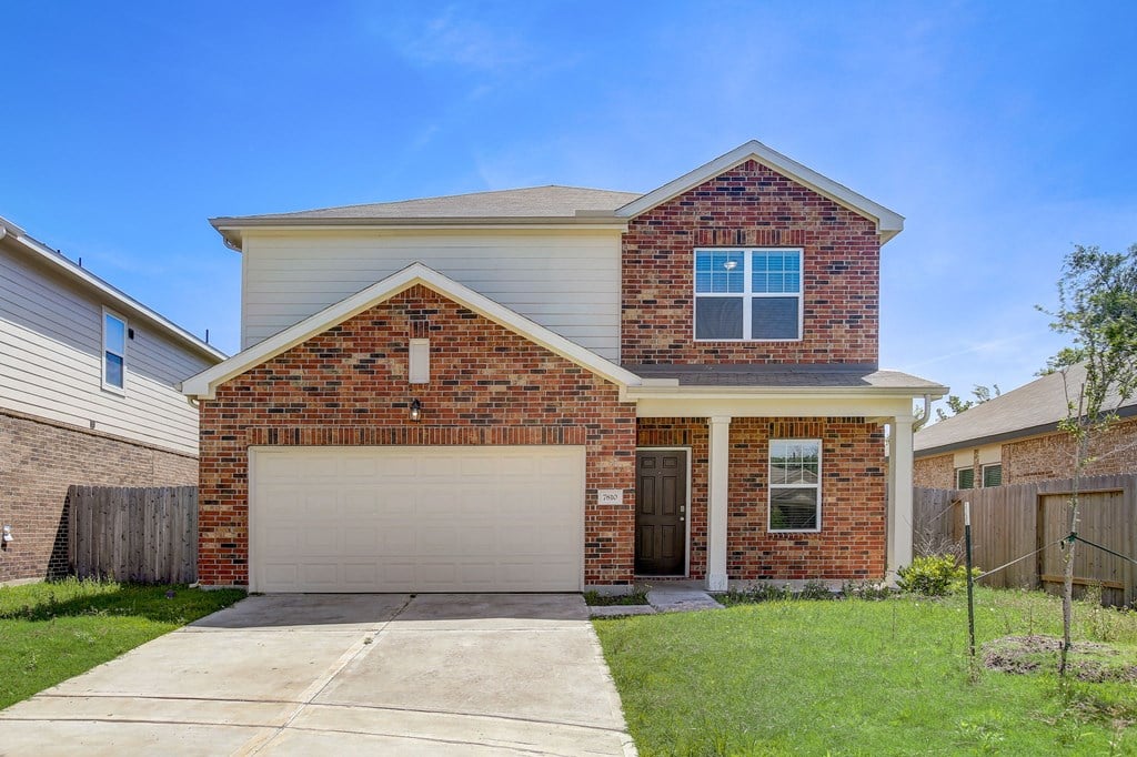 a brick house with a white garage door