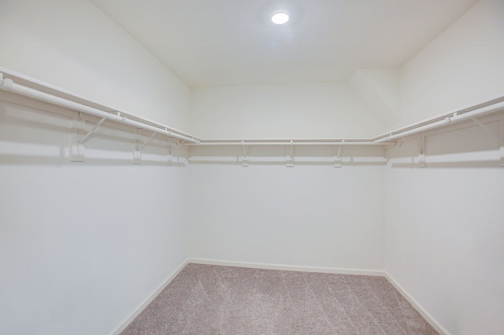 an empty room with white walls and a carpet