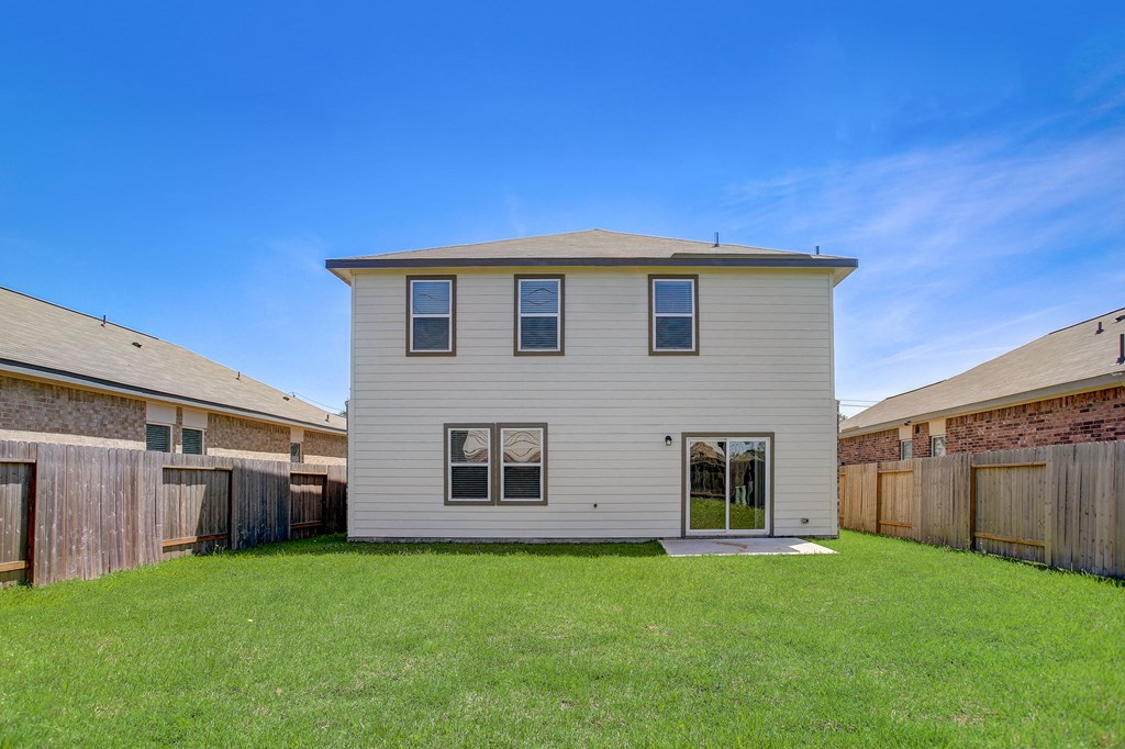 a white house with a yard in front of it