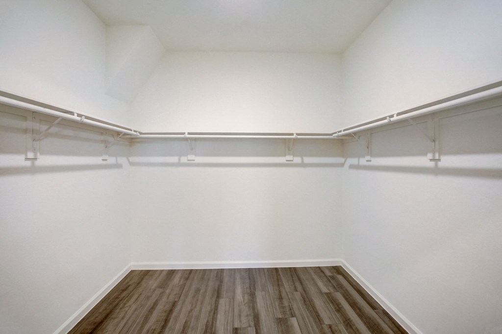 an empty room with white walls and a wooden floor