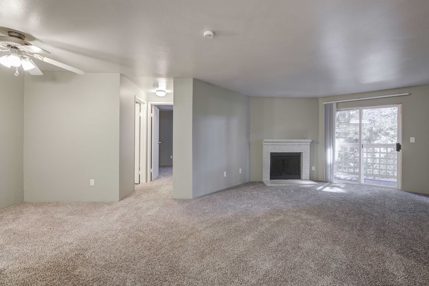 Cascadia Pointe Apartments in Everett, WA photo of a living room with a fireplace and a sliding glass door - Photo Gallery