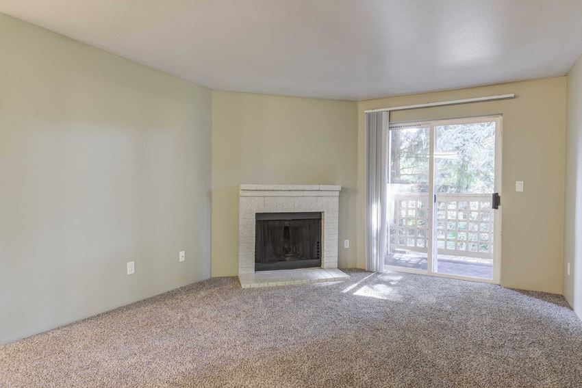 Cascadia Pointe Apartments in Everett, WA photo of a living room with a fireplace and a sliding glass door - Photo Gallery