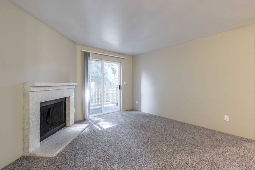 Cascadia Pointe Apartments in Everett, WA photo of a living room with a fireplace and a patio door - Photo Gallery