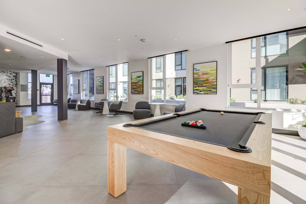 a games room with a pool table in a house
