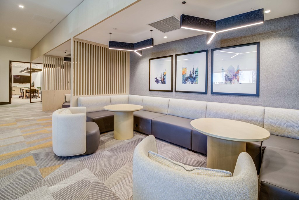 a lobby with couches and chairs and tables
