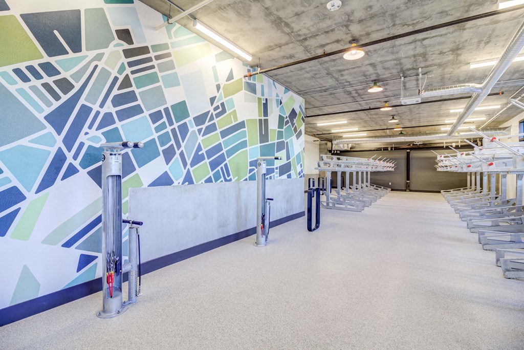 a row of bleachers in a gym with a mural on the wall