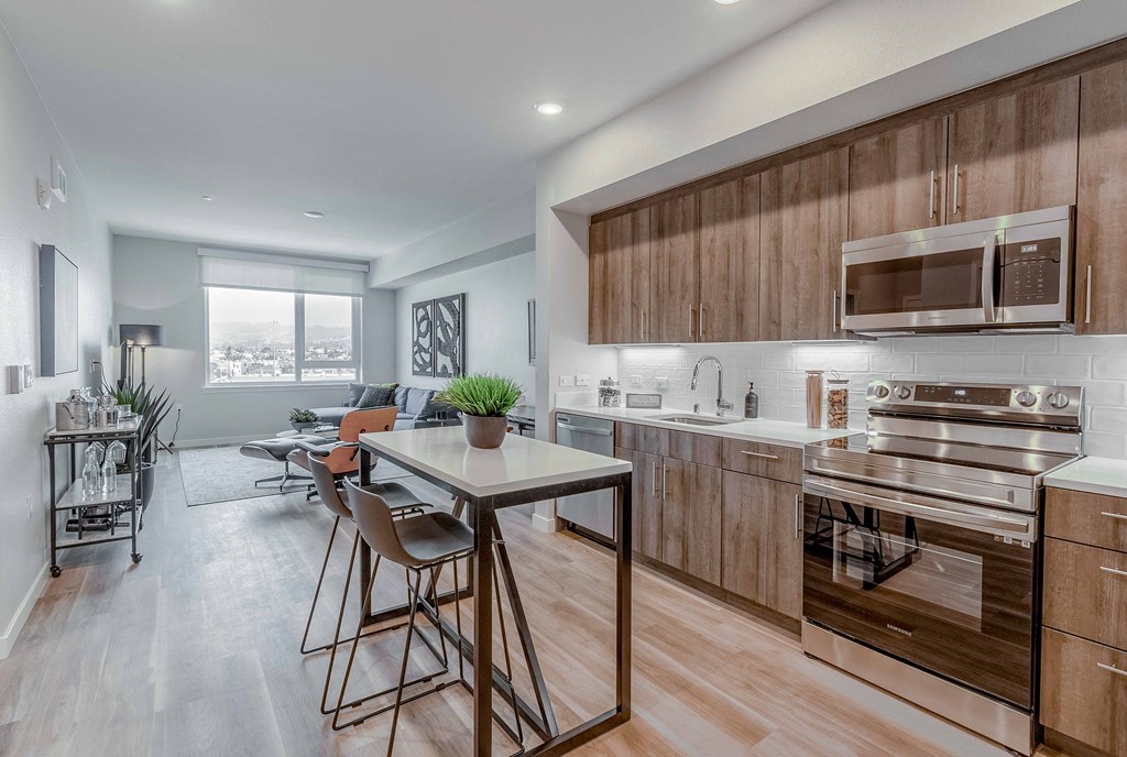 a kitchen with wooden cabinets and a table with chairs