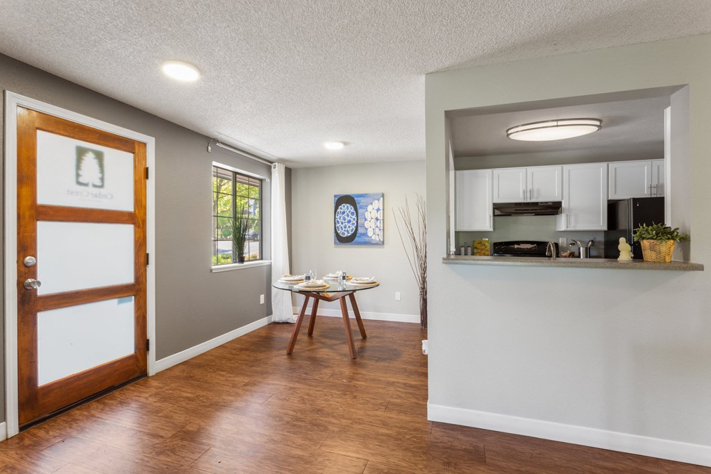 A kitchen area with a dining table and chairs. at Cedar Crest, Beaverton, 97078