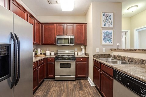 a kitchen with stainless steel appliances and wooden cabinets
