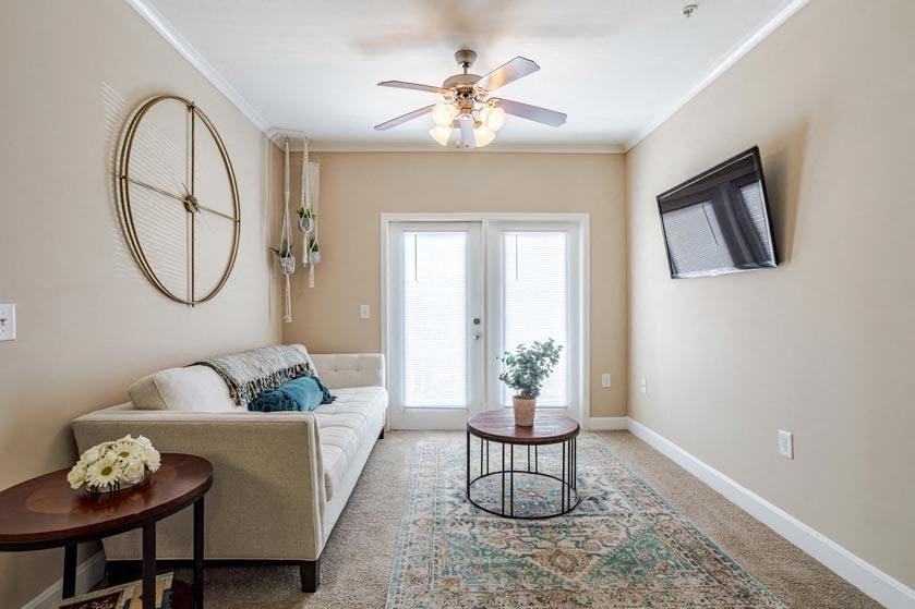 Apartments for Rent in Oak Ridge, TN 37830 – Centennial Village – a living room with a couch and a ceiling fan