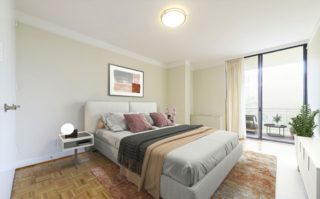 A bedroom with a large bed and a view of the balcony.