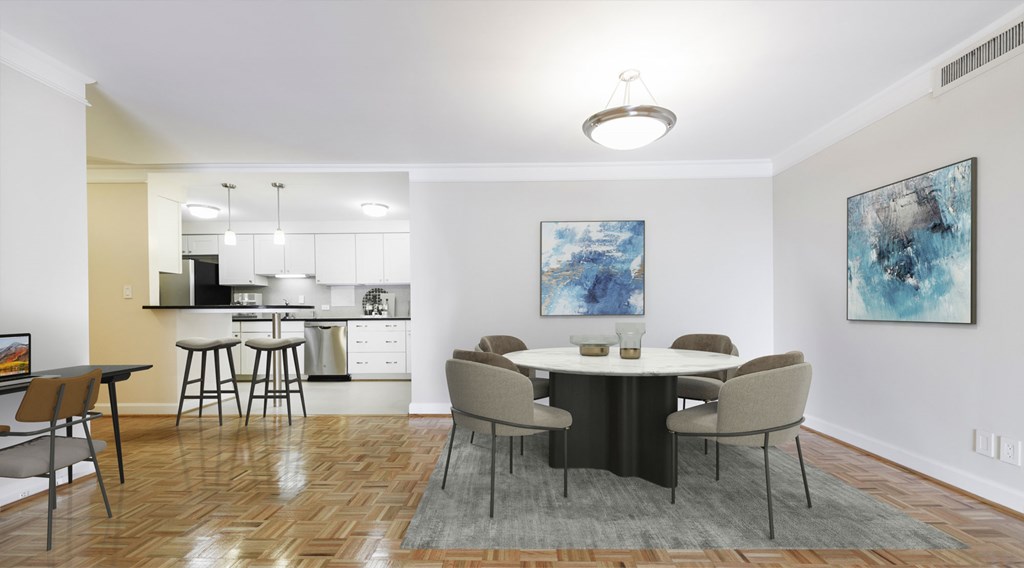A dining room with a table set for four.