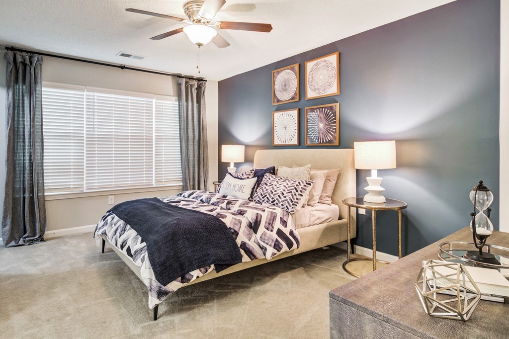 a bedroom with a bed and a ceiling fan