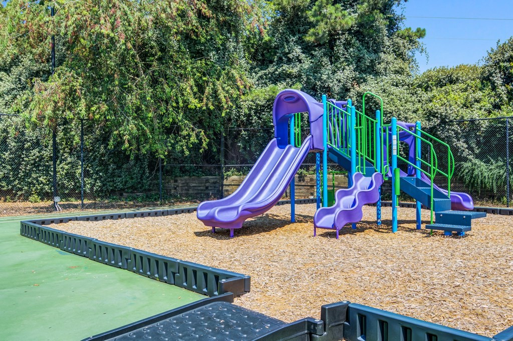 a playground with a slide and a ping pong table