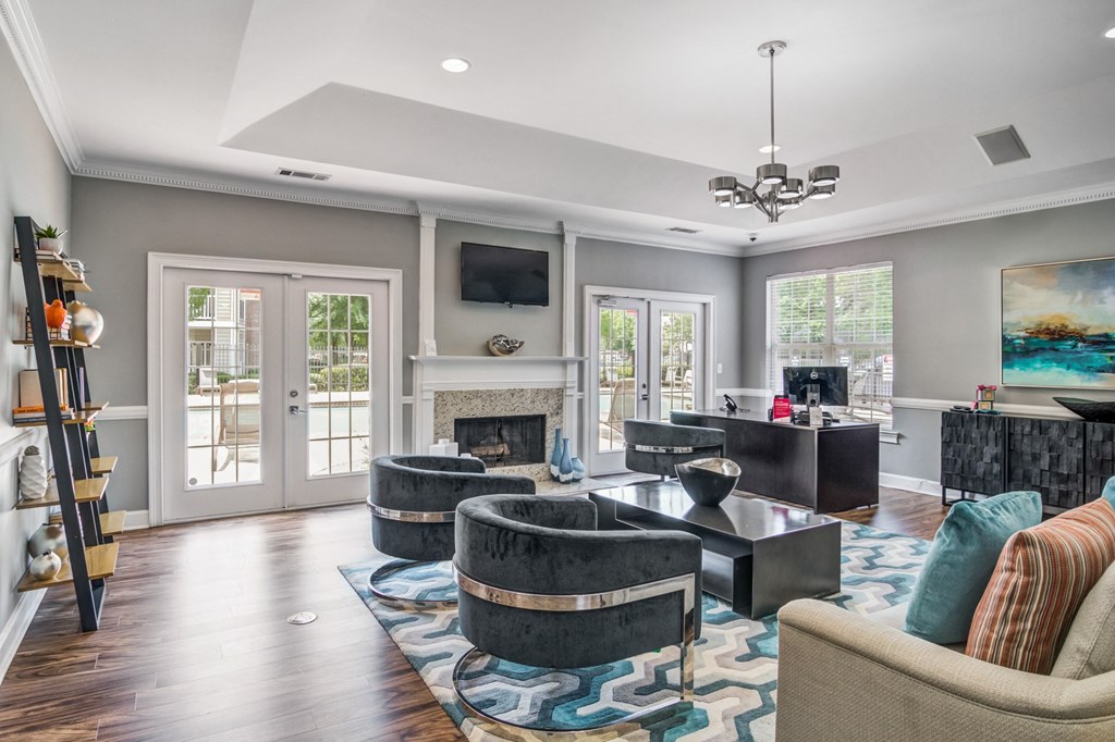 a living room with couches and chairs and a fireplace