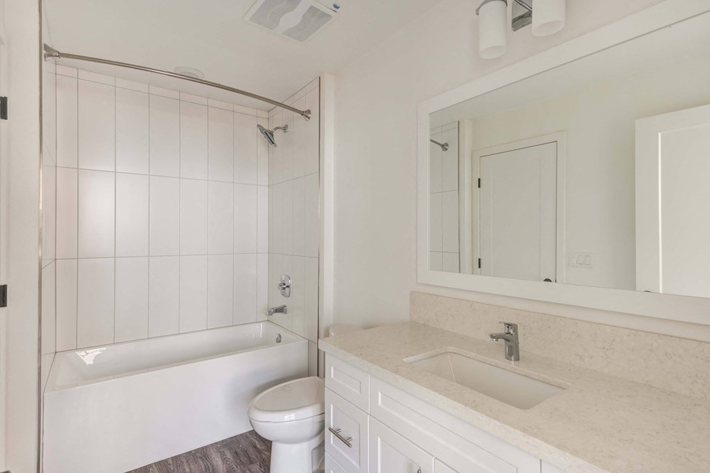 a bathroom with a sink and a toilet and a tub