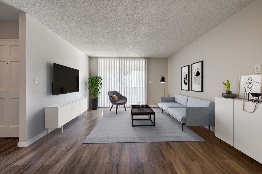 Pet-Friendly Apartments in Huntington Beach CA - Citron House - Living Room with Wood-Style Flooring and Access to Private Patio/Balcony - Photo Gallery 1