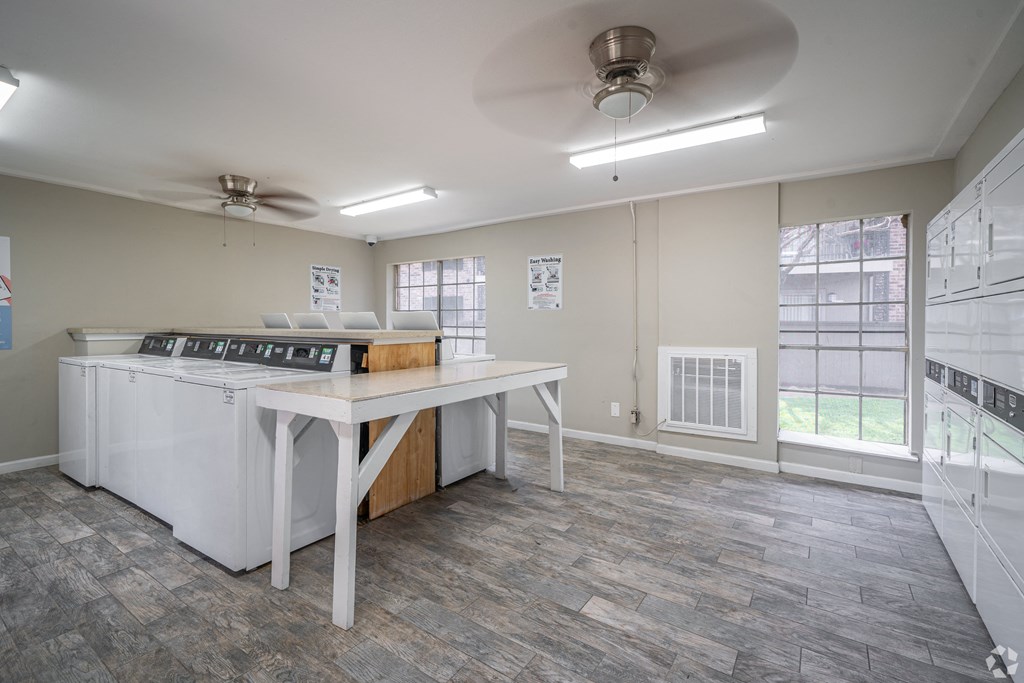 an empty kitchen with an island and a stove and a window