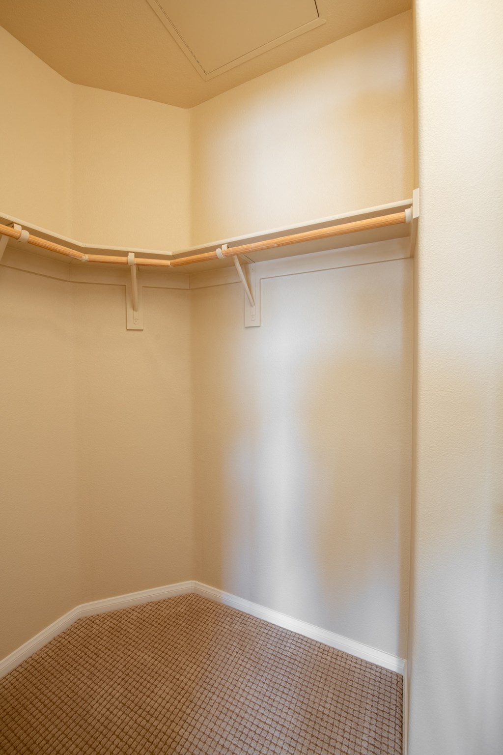 an empty room with a closet and a white wall