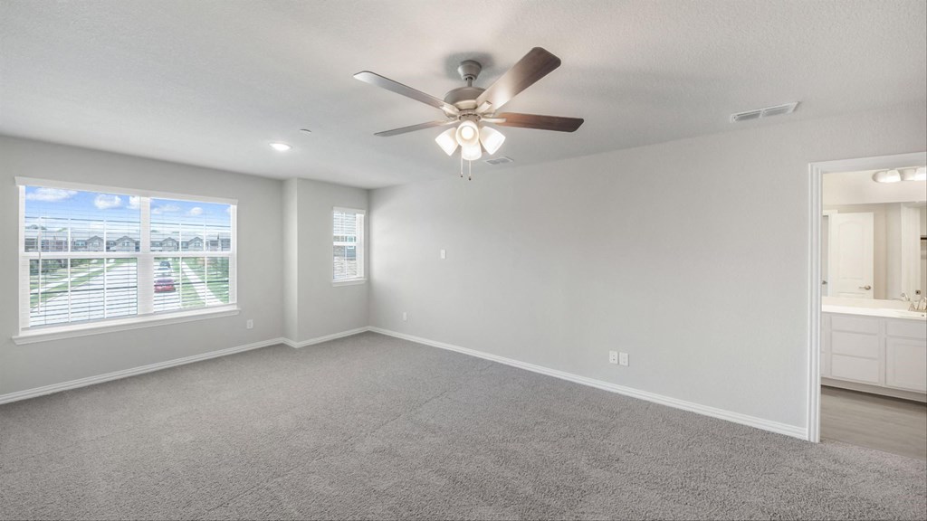 an empty living room with a ceiling fan and a window