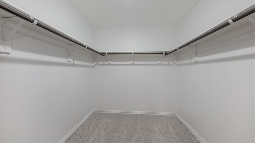 the interior of an empty room with white walls and a carpet