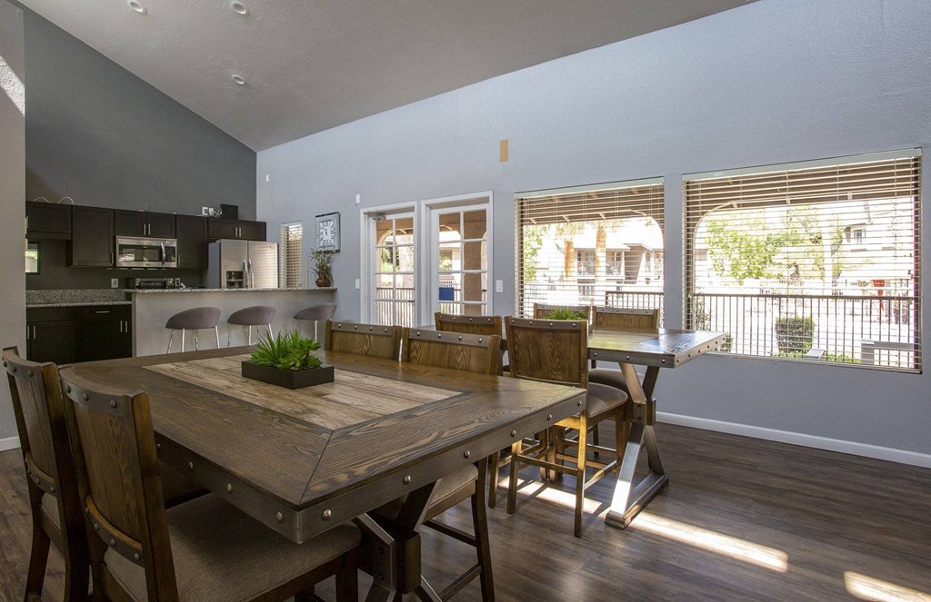 a large dining room with a wooden table and chairs