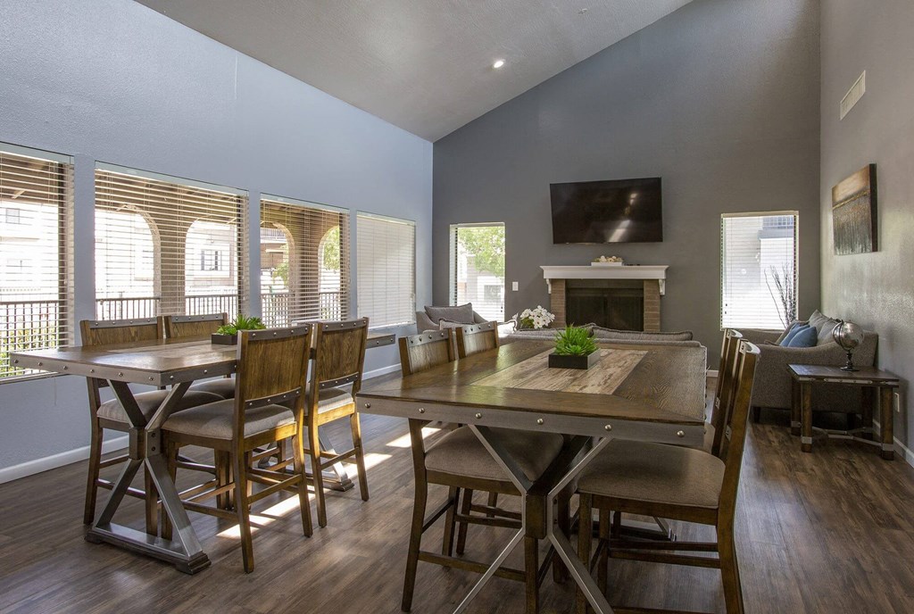 a living room with a table and chairs and a fireplace