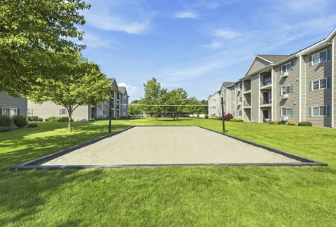 A large grassy area in front of apartment buildings.