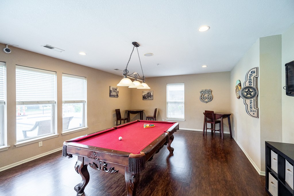 a game room with a red pool table