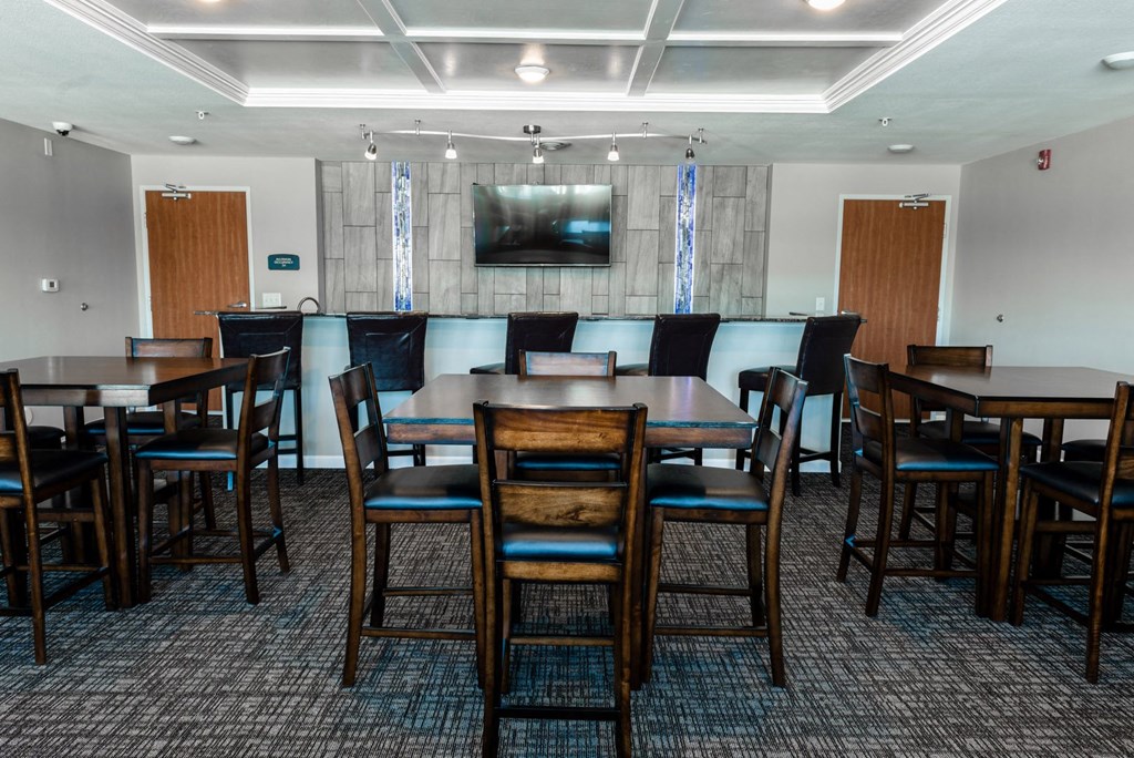 a conference room with tables and chairs and a television