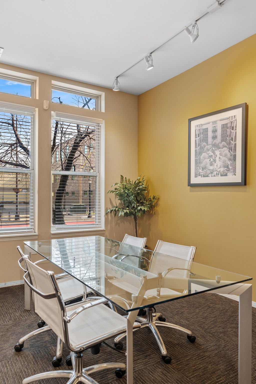 A conference room with a glass table and chairs.
