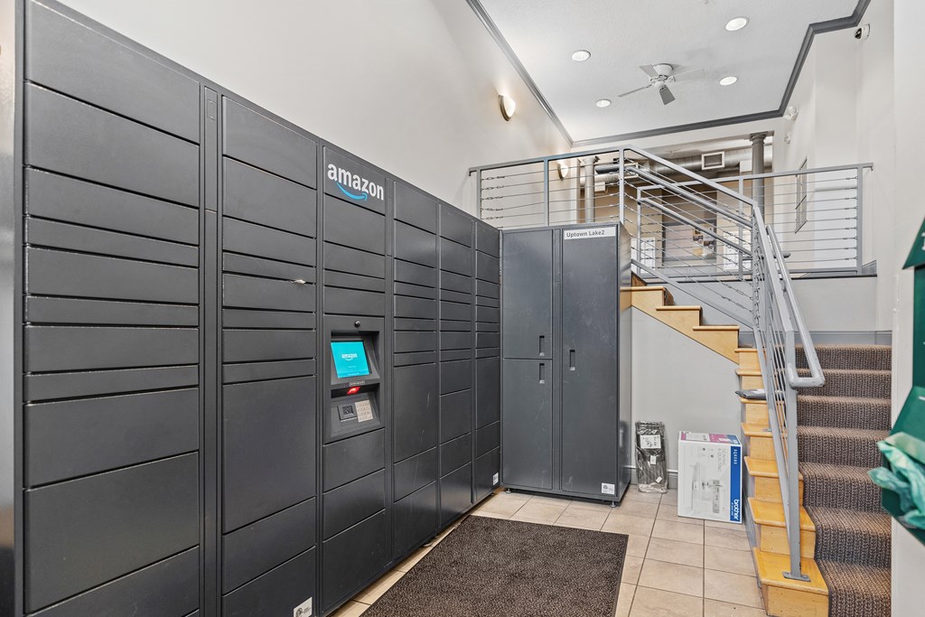 A row of Amazon lockers are lined up in a hallway.