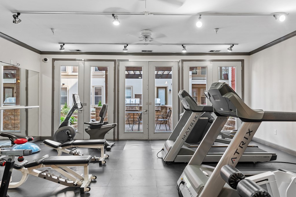 A gym with treadmills and exercise equipment.