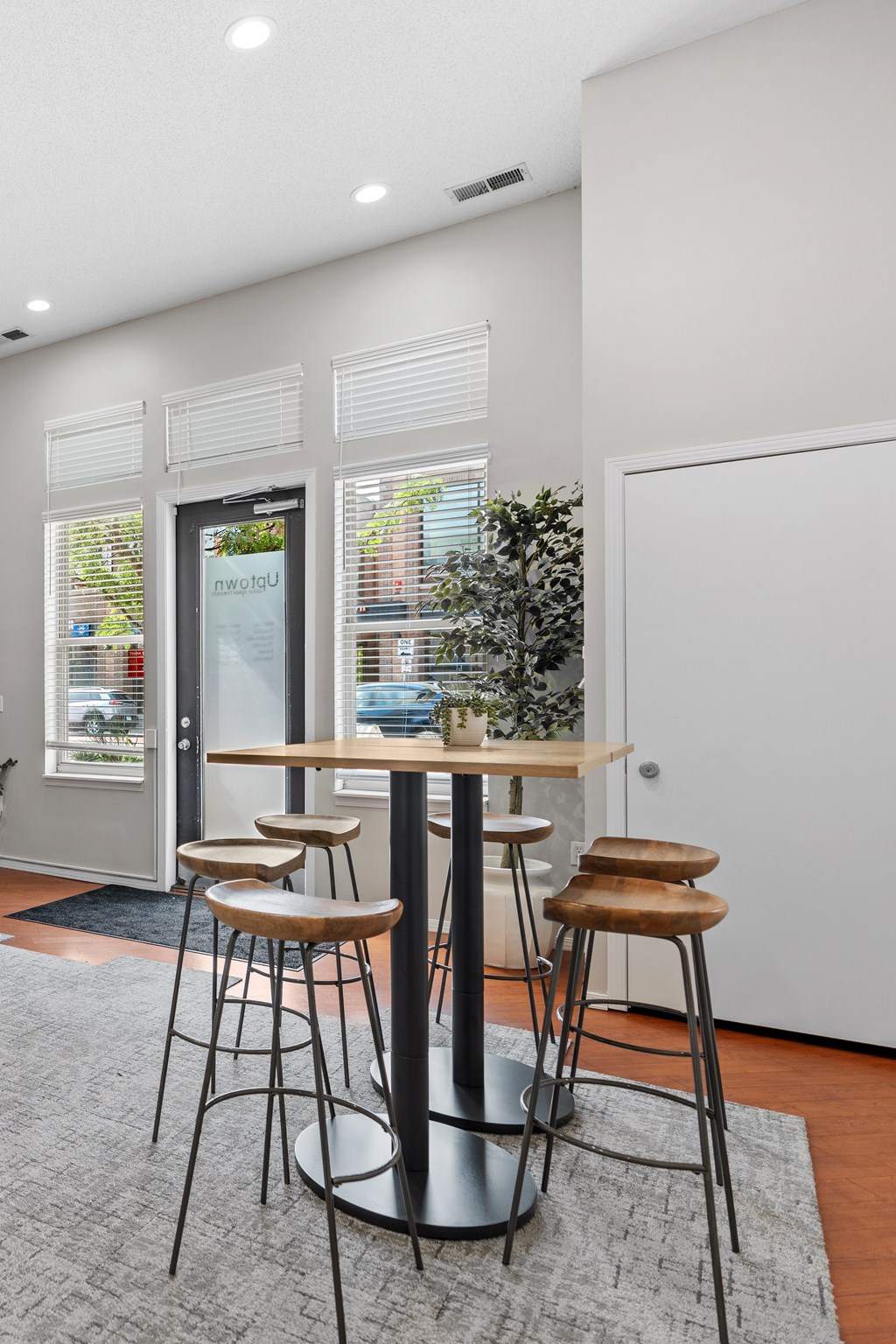 A bar area with a table and two stools.