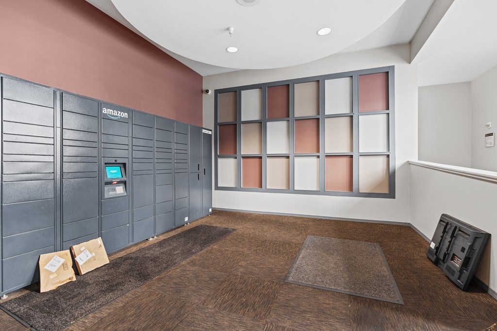 A room with a brown carpet and a wall with Amazon written on it.