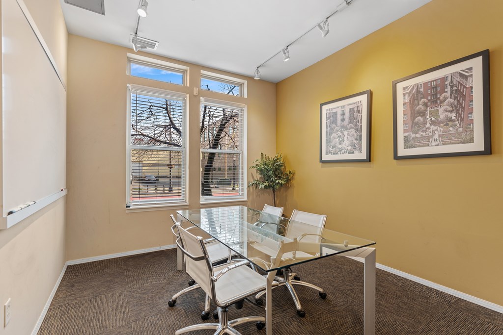 A conference room with a glass table and chairs.