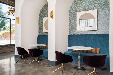 A room with a white table and chairs with gold legs.