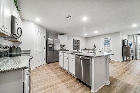 a kitchen with stainless steel appliances and a counter top