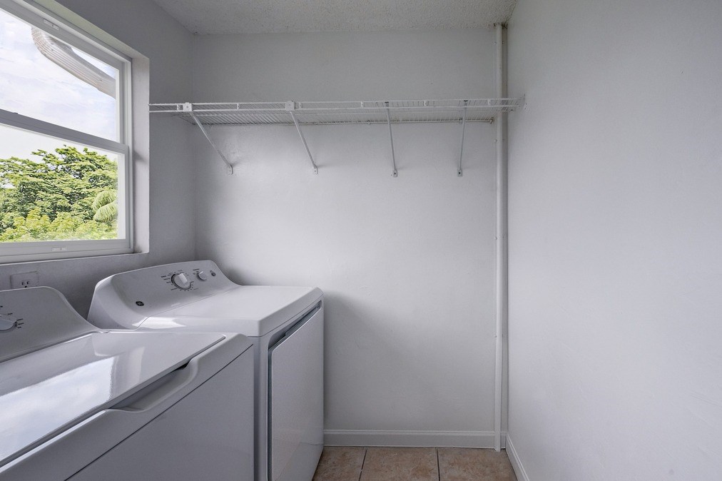 In-home washer and dryer setup at Coronado Springs Apartments in Palm Springs, FL. Convenient laundry area in a pet-friendly community