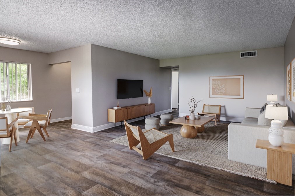 Open living area with wood-style flooring and large windows at Coronado Springs Apartments in Palm Springs, FL. Pet-friendly one- and two-bedroom apartments for rent.